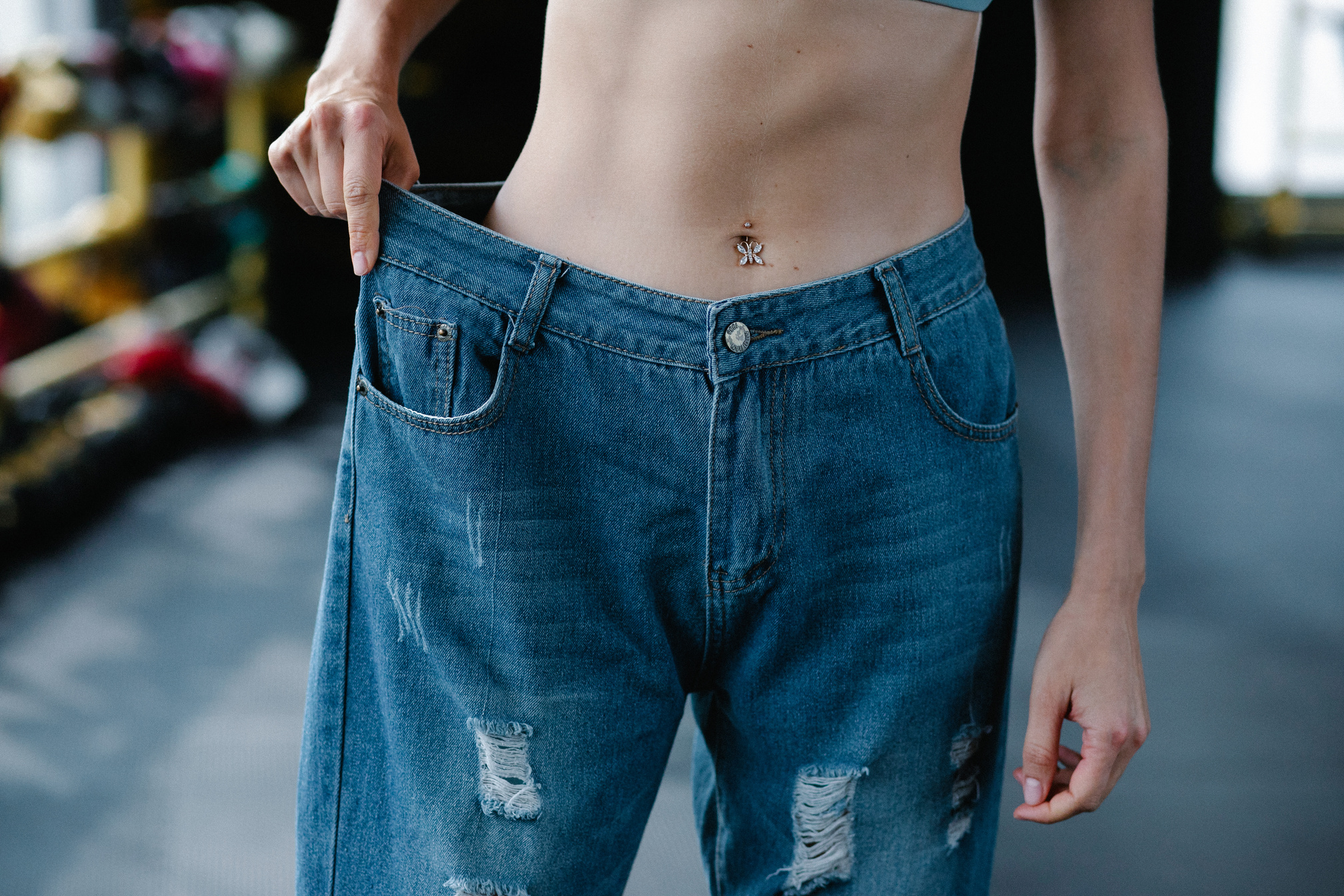 Close-up of Woman Wearing Loose Pants after Diet